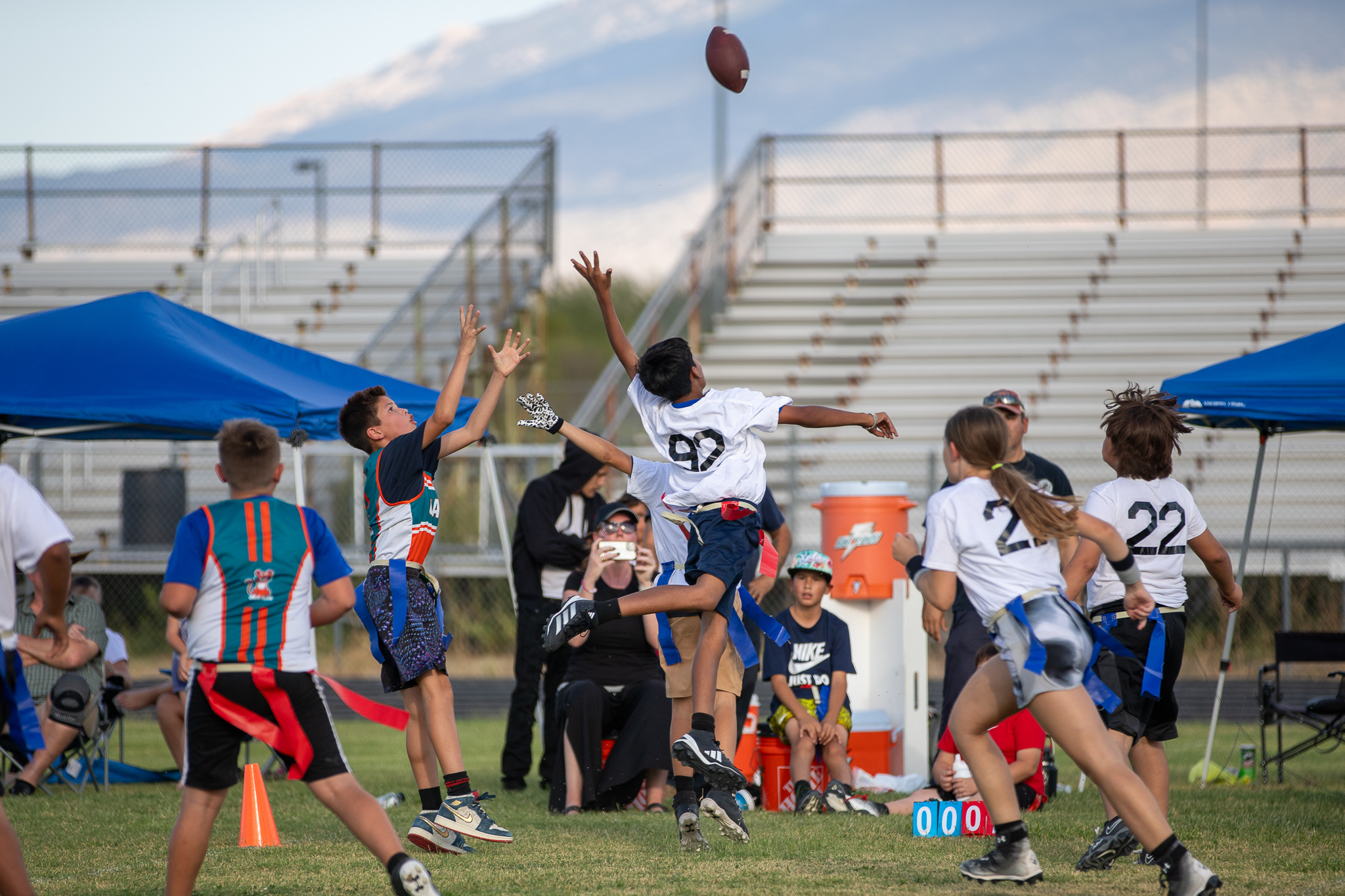 The football is thrown in the air in a dramatic pass!