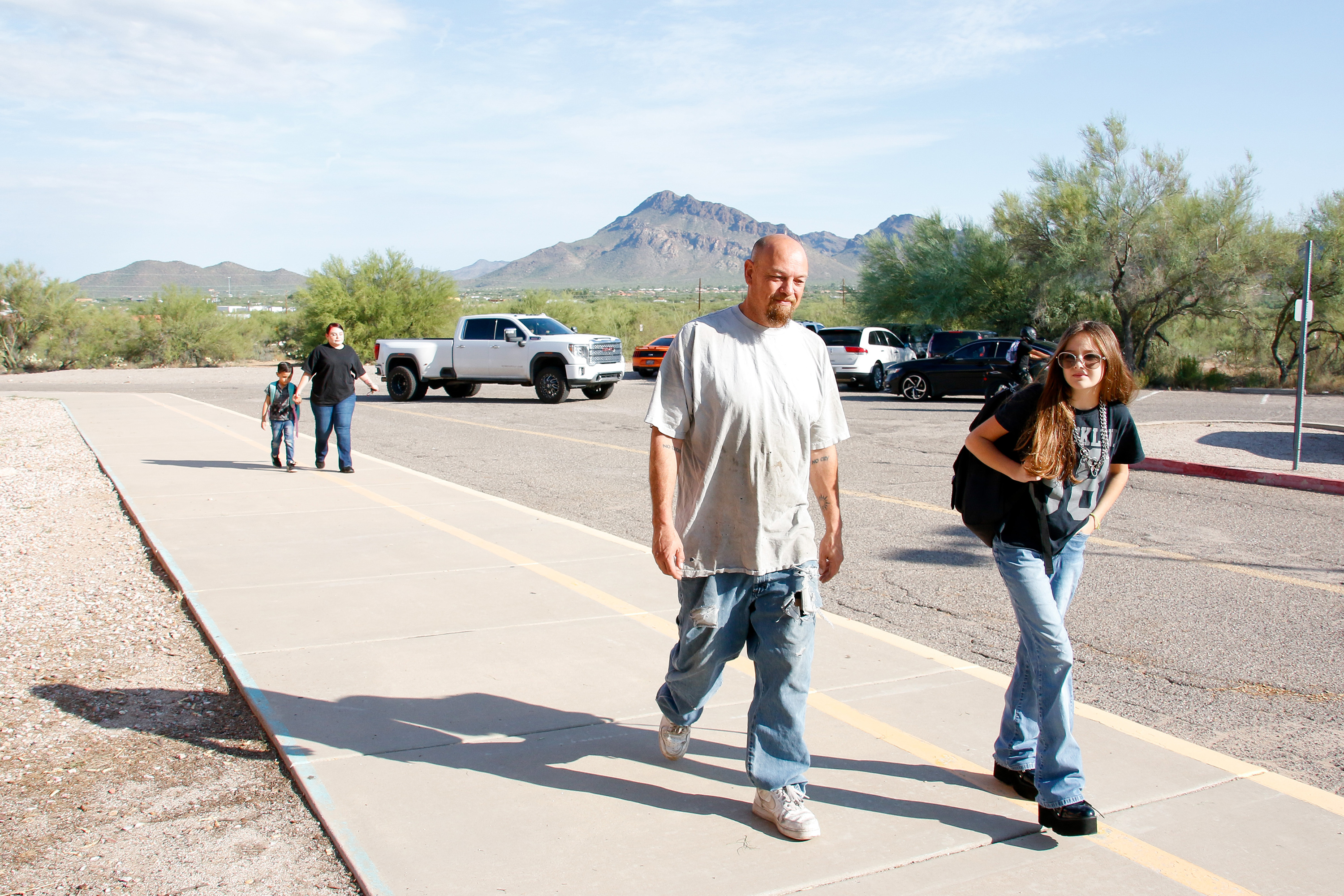 A dad walks in with his daughter on the first day