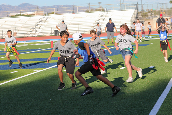 Three Vesey players chase a Miller player down the field
